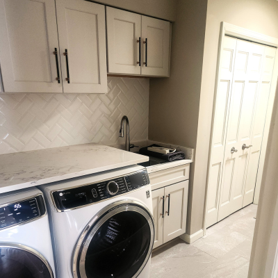 Laundry room with built-in sink, cabinets, and countertops